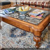 F07. Ethan Allen “Deveraux”glass top coffee table with iron scrollwork.  19”h x 49”w x 35.5”d 